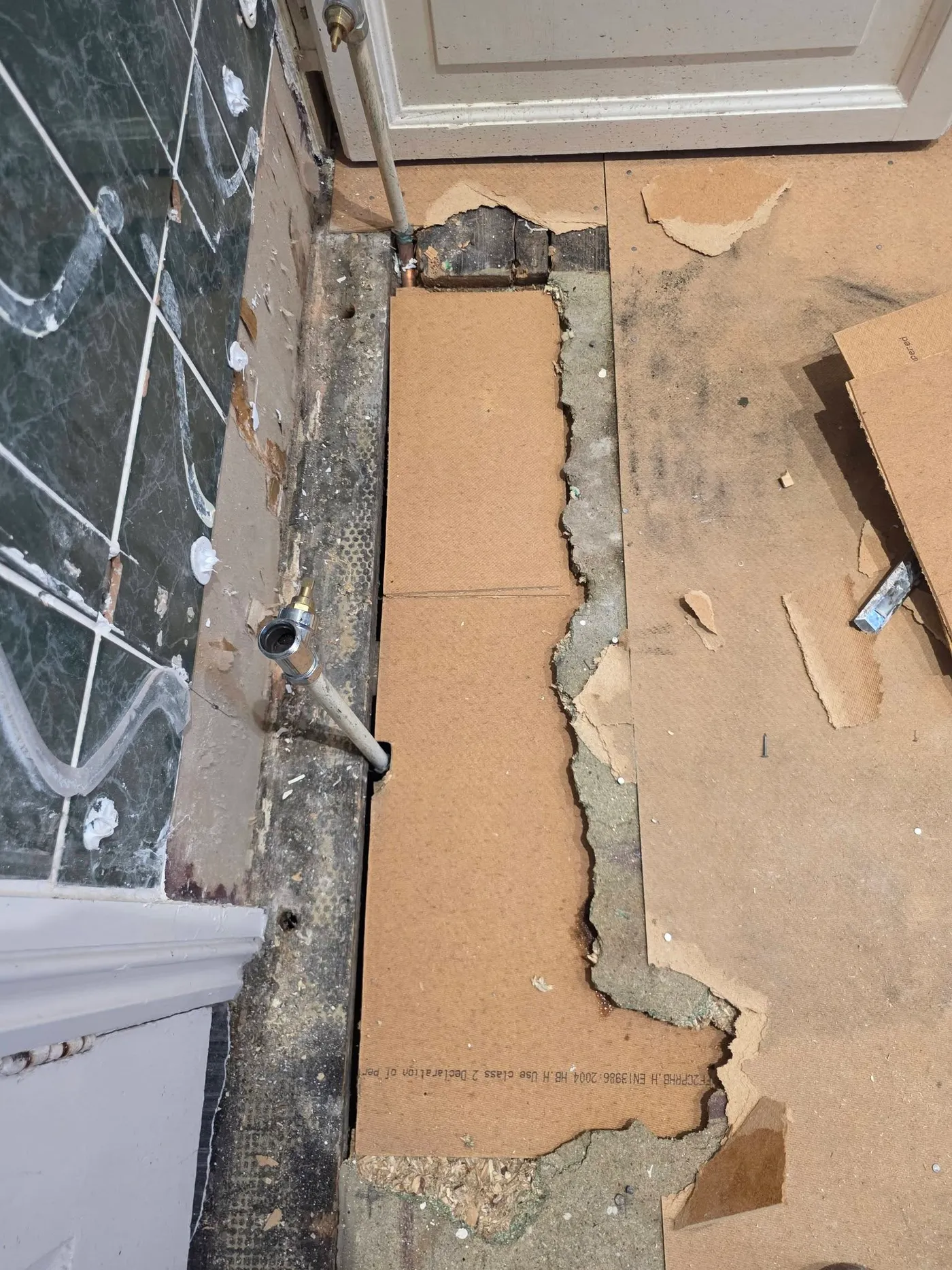 The shower wall opened up during the removal of existing boards.