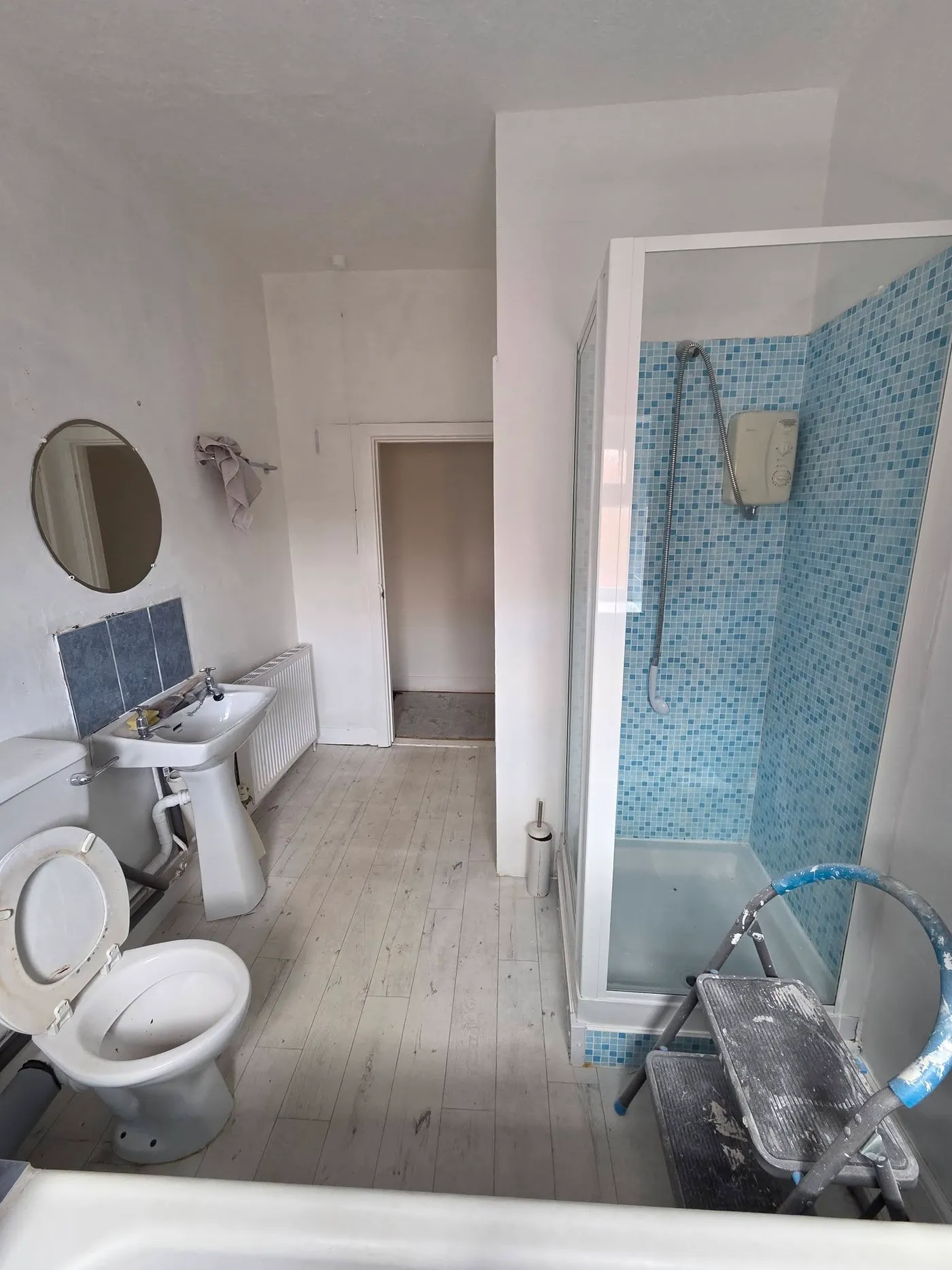 The original shower enclosure, toilet and basin before the strip-out.