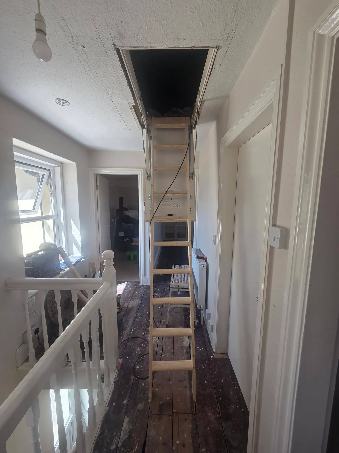 The loft access opening and ladder during the works.