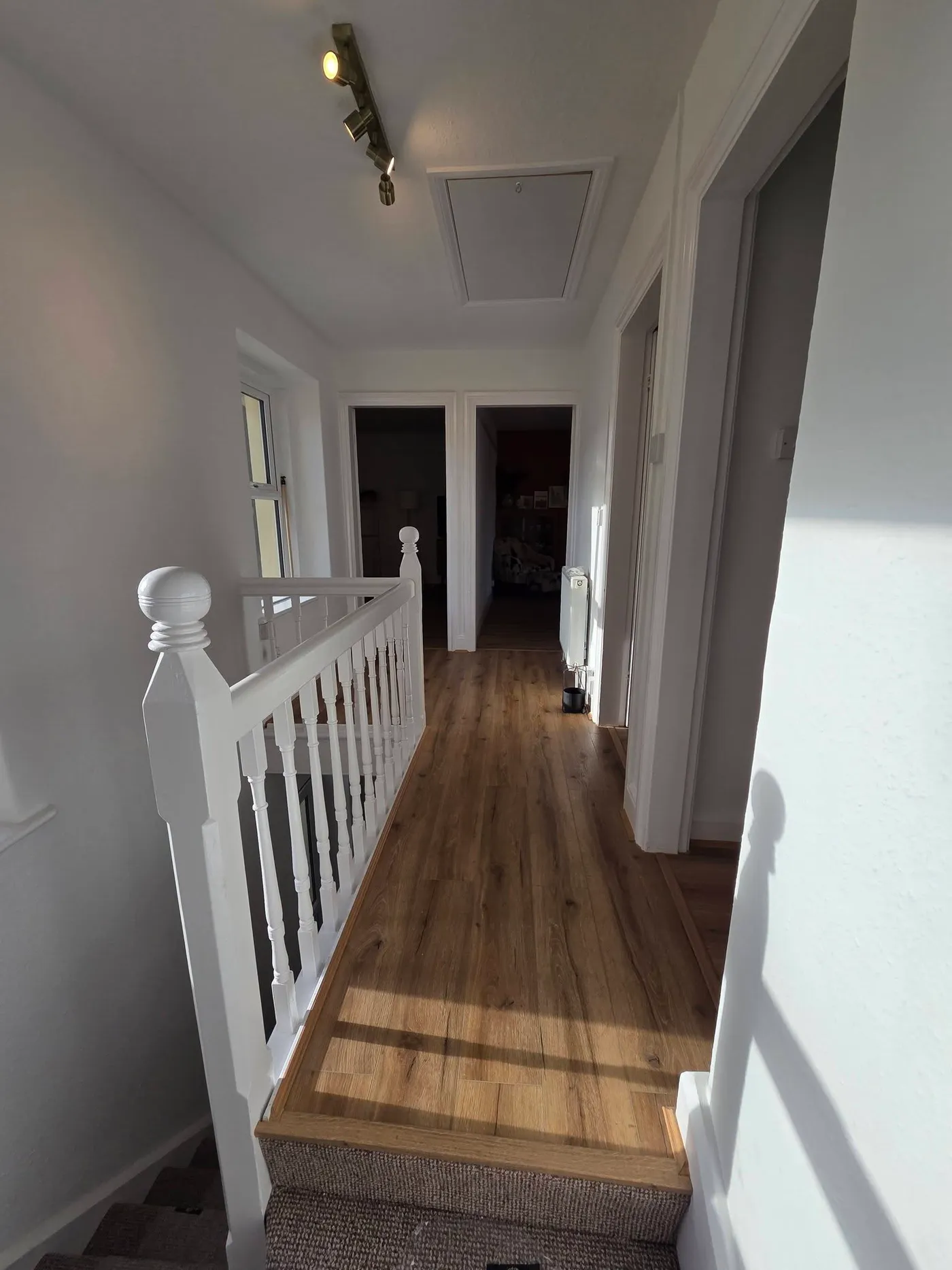 The landing with finished flooring and refreshed walls.