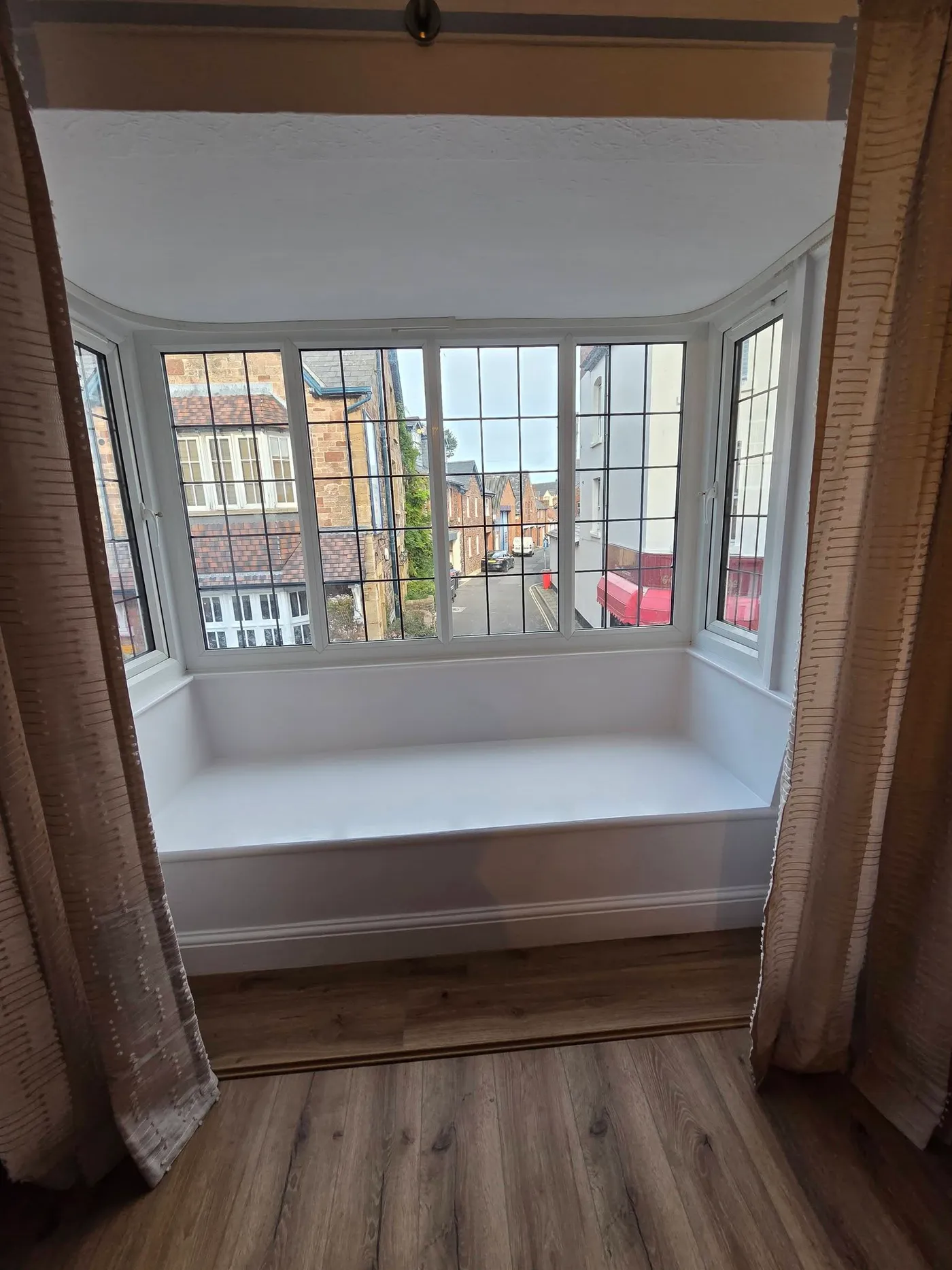 The living room bay window and finished floor.